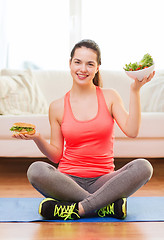 Image showing smiling teenager with green salad and hamburger