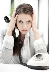 Image showing stressed and tired businesswoman with cell phone