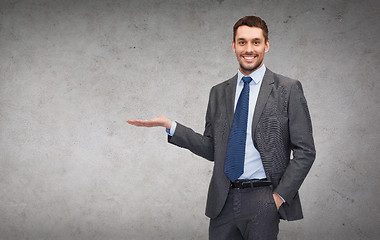 Image showing man showing something on the palm of his hand