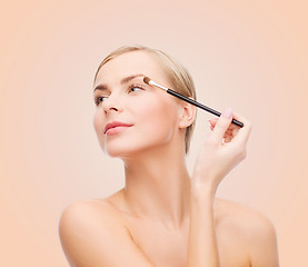 Image showing beautiful woman with makeup brush