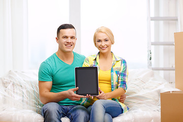 Image showing couple relaxing on sofa with tablet pc in new home