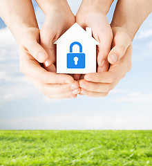 Image showing hands holding paper house with lock