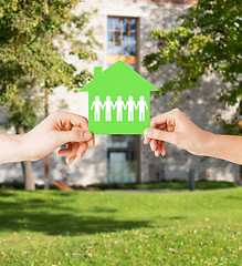 Image showing man and woman hands with paper house