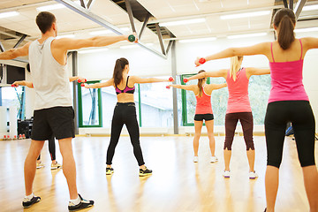 Image showing people working out with dumbbells from the back