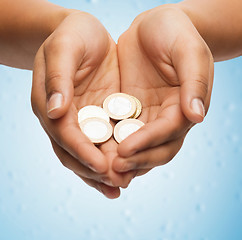 Image showing womans cupped hands showing euro coins