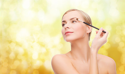 Image showing beautiful woman with makeup brush