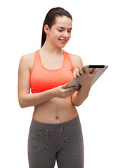 Image showing sporty woman with tablet pc computer