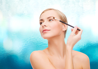 Image showing beautiful woman with makeup brush