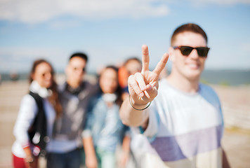 Image showing close up of male hand showing v-sign with fingers