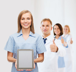 Image showing smiling female doctor or nurse with tablet pc