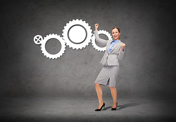 Image showing happy businesswoman with hands up