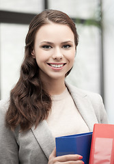 Image showing beautiful smiling woman with folder