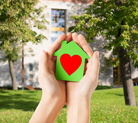 Image showing hands holding green paper house