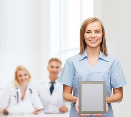 Image showing smiling female doctor or nurse with tablet pc