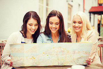 Image showing beautiful girls looking into tourist map in city