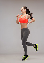 Image showing sporty woman running or jumping