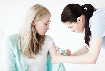 Image showing doctor doing vaccine to patient