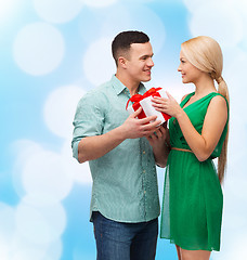 Image showing smiling couple with gift box