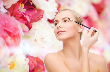 Image showing beautiful woman with makeup brush