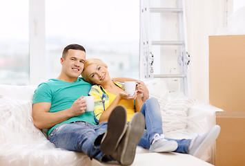 Image showing smiling couple relaxing on sofa in new home