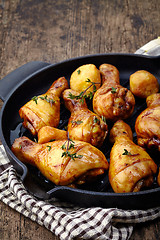 Image showing Roasted chicken legs and potatoes