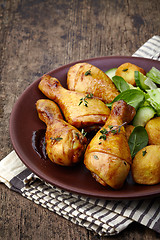 Image showing Roasted chicken legs and potatoes