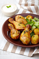 Image showing Roasted chicken legs and potatoes