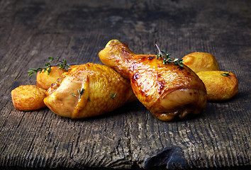 Image showing Roasted chicken legs and potatoes