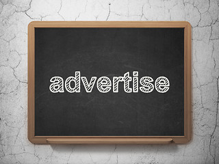 Image showing Advertising concept: Advertise on chalkboard background