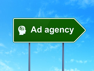 Image showing Advertising concept: Ad Agency and Head With Finance Symbol on road sign background