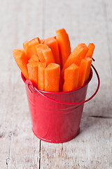 Image showing fresh sliced carrot in red bucket 