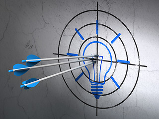 Image showing Business concept: arrows in Light Bulb target on wall background