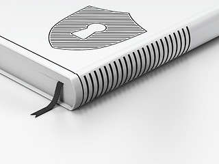 Image showing Privacy concept: closed book, Shield With Keyhole on white background