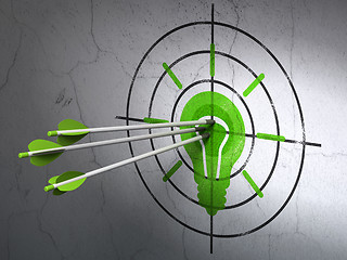 Image showing Finance concept: arrows in Light Bulb target on wall background