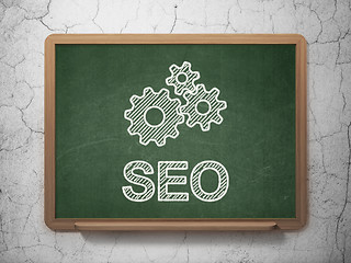 Image showing Web design concept: Gears and SEO on chalkboard background