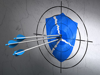 Image showing Security concept: arrows in Broken Shield target on wall background