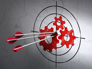 Image showing Advertising concept: arrows in Gears target on wall background