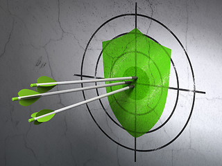 Image showing Protection concept: arrows in Shield target on wall background