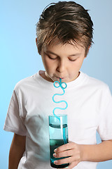 Image showing Child drinking through a straw