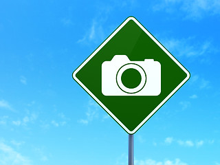 Image showing Travel concept: Photo Camera on road sign background