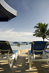 Image showing chaise lounge chairs infinity pool