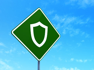Image showing Safety concept: Contoured Shield on road sign background