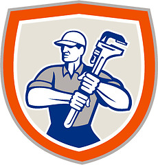 Image showing Plumber Holding Giant Monkey Wrench Shield 