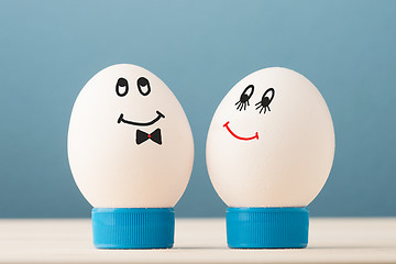 Image showing Two white eggs with smiles, male and female, man and woman.