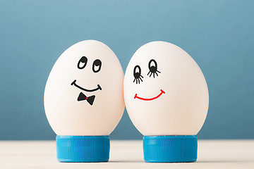 Image showing Two white eggs with smiles, male and female, man and woman.