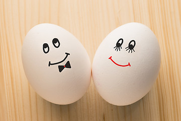 Image showing Two white eggs with smiles, male and female, man and woman.