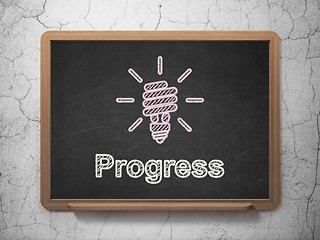 Image showing Business concept: Energy Saving Lamp and Progress on chalkboard background