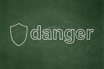 Image showing Security concept: Shield and Danger on chalkboard background