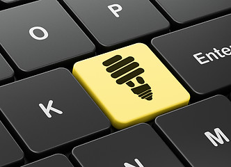 Image showing Finance concept: Energy Saving Lamp on computer keyboard background