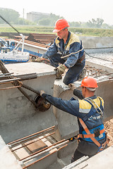 Image showing Workers mouning bridge span